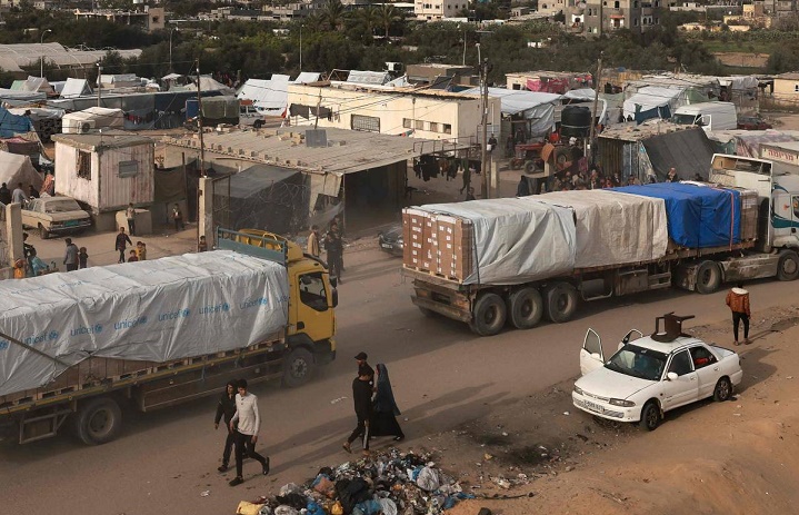 Trucks carrying humanitarian aid enter Rafah in the southern Gaza Strip after crossing the terminal border from Egypt, on January 17, 2024, amid the ongoing conflict between Israel and the Palestinian militant group Hamas. (Photo by AFP)