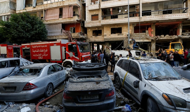 People gather near a firetruck and damaged vehicles at the site of Friday’s Israeli strike, as search and rescue operations continue, in Beirut’s southern suburbs, Lebanon September 21, 2024. REUTERS/Amr Abdallah Dalsh