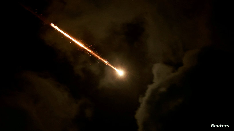 FILE PHOTO: A projectile is seen in the sky after Iran fired a salvo of ballistic missiles, amid cross-border hostilities between Hezbollah and Israel, as seen from Tel Aviv, Israel, October 1, 2024. REUTERS/Ammar Awad/File Photo