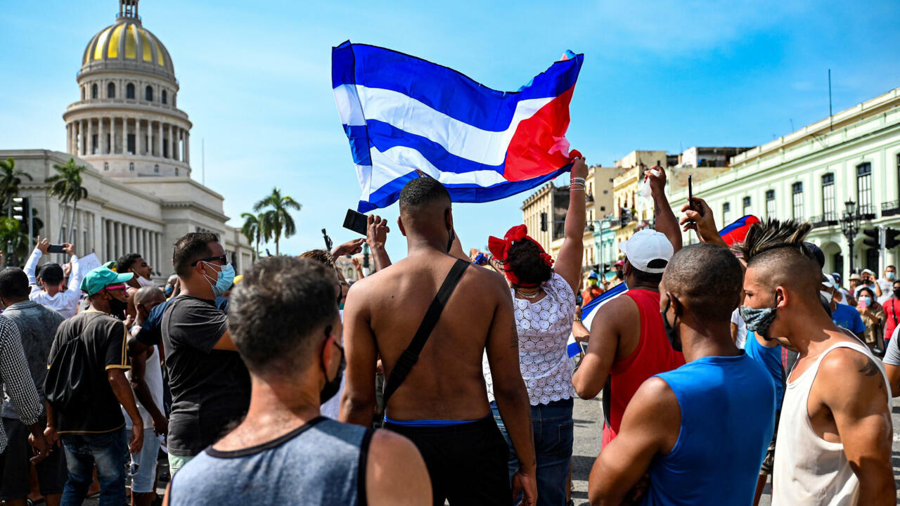 People take part in a demonstration against the government of Cuban President Miguel Diaz-Canel in Havana, on July 11, 2021. Thousands of Cubans took part in rare protests Sunday against the communist government, marching through a town chanting “Down with the dictatorship” and “We want liberty.”